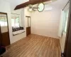 Unfurnished bedroom with wood-style flooring and a mini-split unit