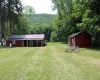 Expansive yard showing back of cottage and garage