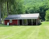 Rear view of house featuring an expansive lawn