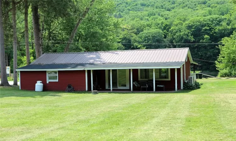 Rear view of house featuring an expansive lawn