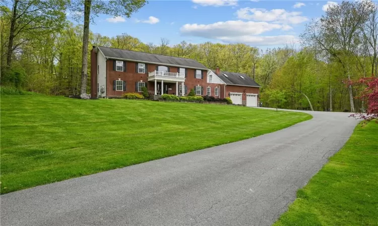 View of front of property featuring a garage and a front yard