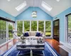 Sunroom / solarium featuring lofted ceiling with skylight