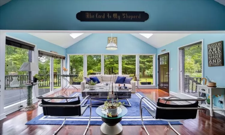 Sunroom featuring vaulted ceiling