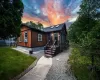 View of front of property with cooling unit and a lawn