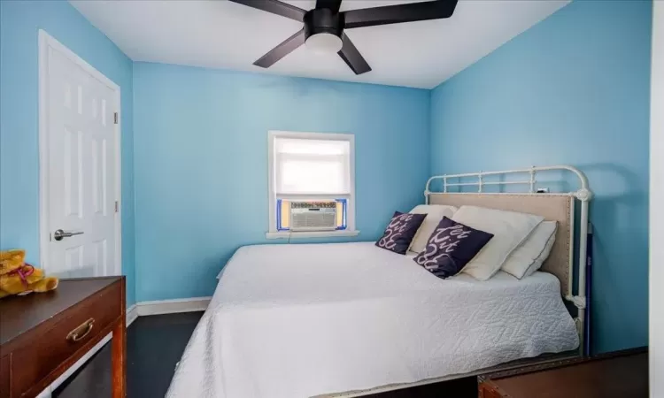 Bedroom featuring ceiling fan and dark hardwood / wood-style floors