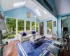 Sunroom with vaulted ceiling with skylight and a healthy amount of sunlight