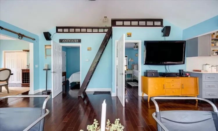 Living room with dark hardwood / wood-style flooring