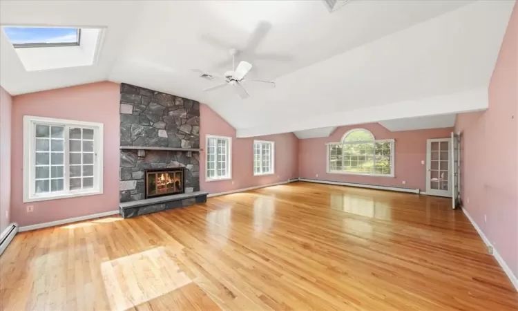 Oversized with cathedral ceilings, wood burning fireplace and skylights.