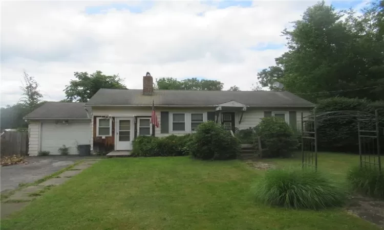 View of front of property with a garage and a front yard