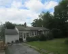 Ranch-style home featuring a garage and a front yard