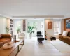 Living room featuring wood-type flooring, built in features, and plenty of natural light