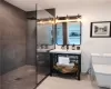 Bathroom featuring vanity, a tile shower, and hardwood / wood-style flooring