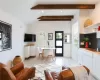 Living room featuring lofted ceiling with beams and light wood-type flooring