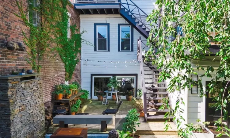 Rear view of house featuring a wooden deck