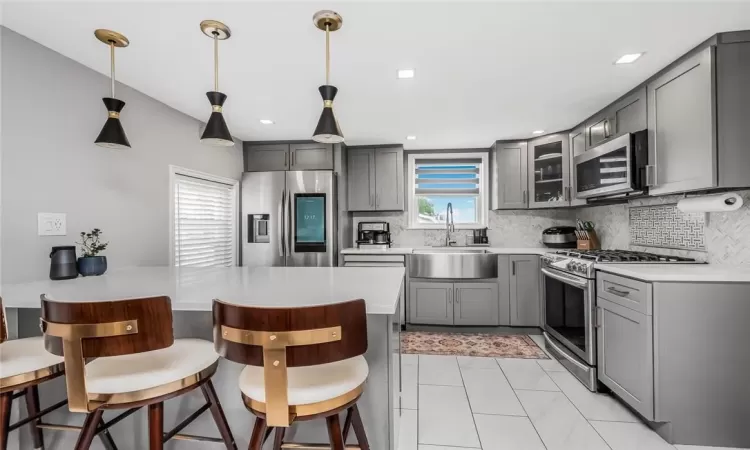 Renovated eat-in-kitchen with quartz counters and stainless steel appliances