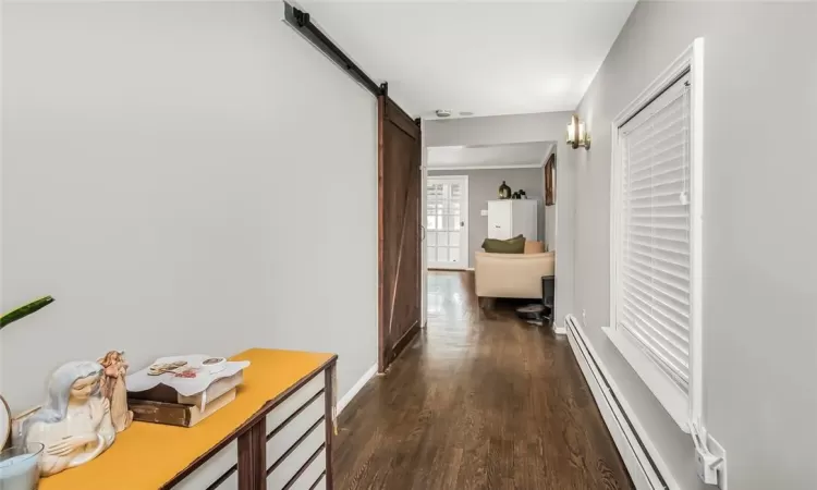 Hallway leads to first floor bedroom, bathroom and eat-in-kitchen