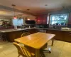 Kitchen featuring stainless steel dishwasher, light tile patterned floors, decorative backsplash, crown molding, and kitchen peninsula