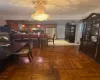 Dining space with crown molding, a notable chandelier, and parquet flooring