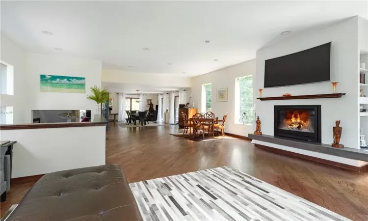 Living room with a healthy amount of sunlight and hardwood / wood-style floors