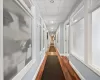 Hall featuring dark wood-type flooring and a paneled ceiling