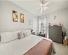 Carpeted bedroom featuring ceiling fan