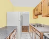 Kitchen featuring light hardwood / wood-style flooring, sink, and white appliances