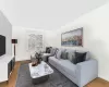 Living room with lofted ceiling and hardwood / wood-style floors