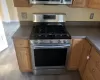 Kitchen featuring appliances with stainless steel finishes and light hardwood / wood-style flooring