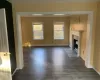 Unfurnished living room featuring a fireplace and dark hardwood / wood-style flooring