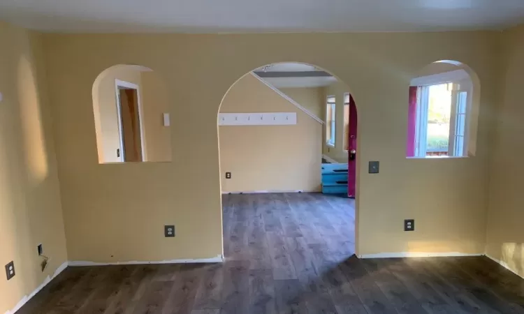 Spare room with dark wood-type flooring