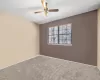 Spare room featuring ceiling fan, carpet floors, and a textured ceiling