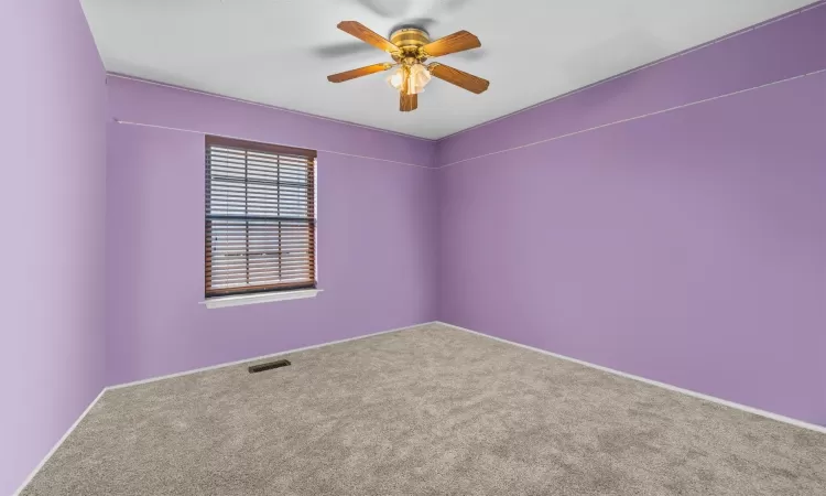 Spare room with carpet flooring and ceiling fan