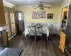 Dining room with ornamental molding, dark wood-type flooring, and ceiling fan