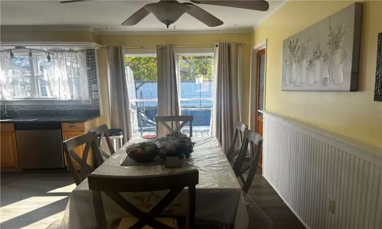 Dining room featuring ornamental molding, ceiling fan, and dark hardwood / wood-style flooring