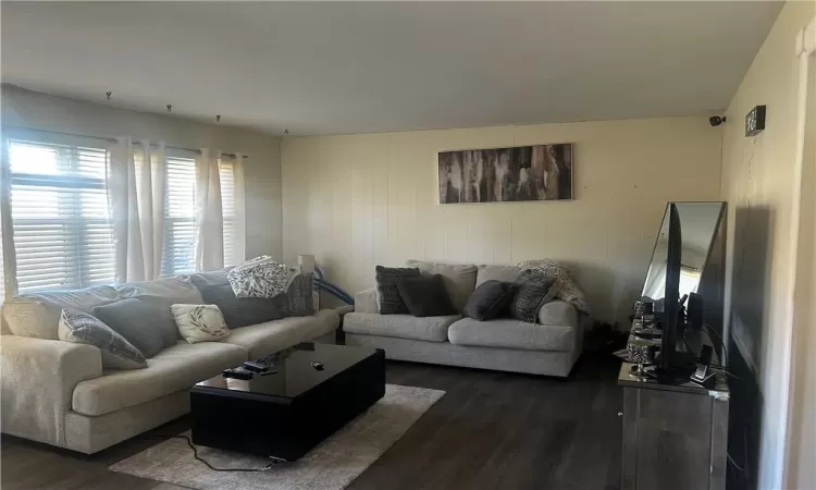 Living room with dark hardwood / wood-style floors