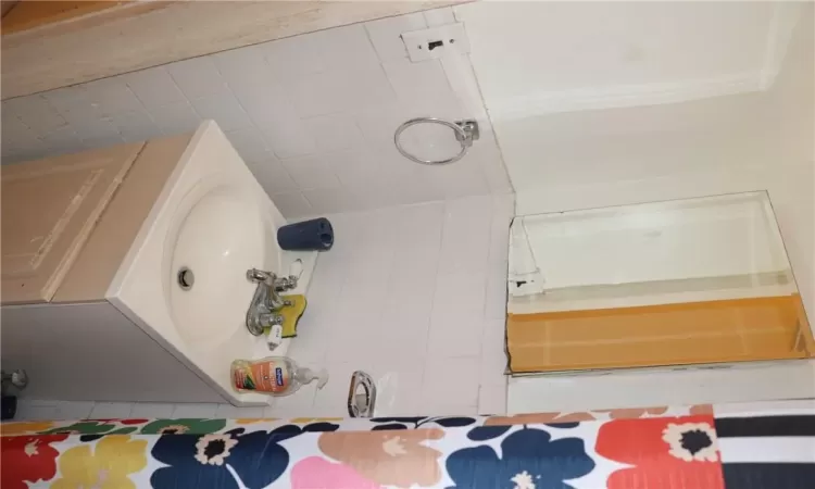 Bathroom with vanity and tile walls