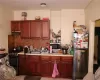 Kitchen featuring sink, appliances with stainless steel finishes, backsplash, and light tile patterned floors