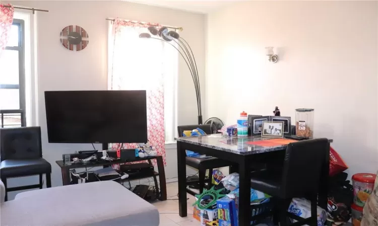 Dining area with light tile patterned floors