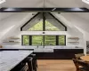 Kitchen featuring light stone counters, sink, light hardwood / wood-style flooring, and lofted ceiling with beams