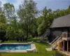 View of pool with a patio and a yard