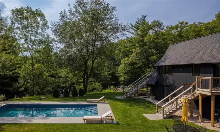 View of pool with a patio and a yard