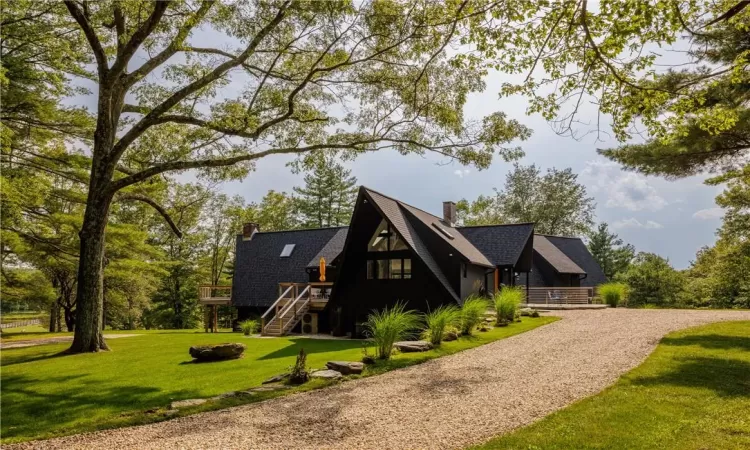 View of front of house with a front lawn and a deck