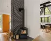 Room details featuring a wood stove, hardwood / wood-style flooring, and sink