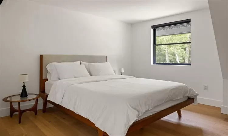 Bedroom with hardwood / wood-style floors