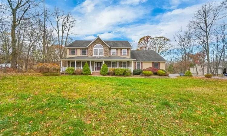 Colonial house with a porch and a front lawn