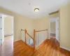 Hallway with light hardwood / wood-style floors and baseboard heating