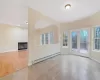 Unfurnished room with light hardwood / wood-style flooring, a healthy amount of sunlight, and a baseboard heating unit