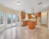 Kitchen featuring a healthy amount of sunlight, dishwasher, pendant lighting, and a kitchen island