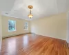 Unfurnished room with baseboard heating and light wood-type flooring