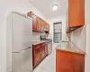 Kitchen with stainless steel appliances, sink, light stone counters, tasteful backsplash, and light tile patterned floors